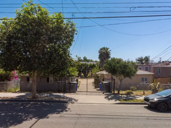 a front view of a house with trees