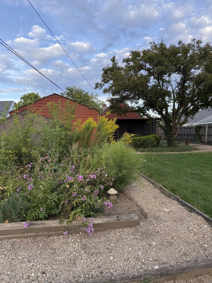 426 South Adeline Avenue Addison, IL 60101 - Photo 12 of 13 a view of a garden with a lake