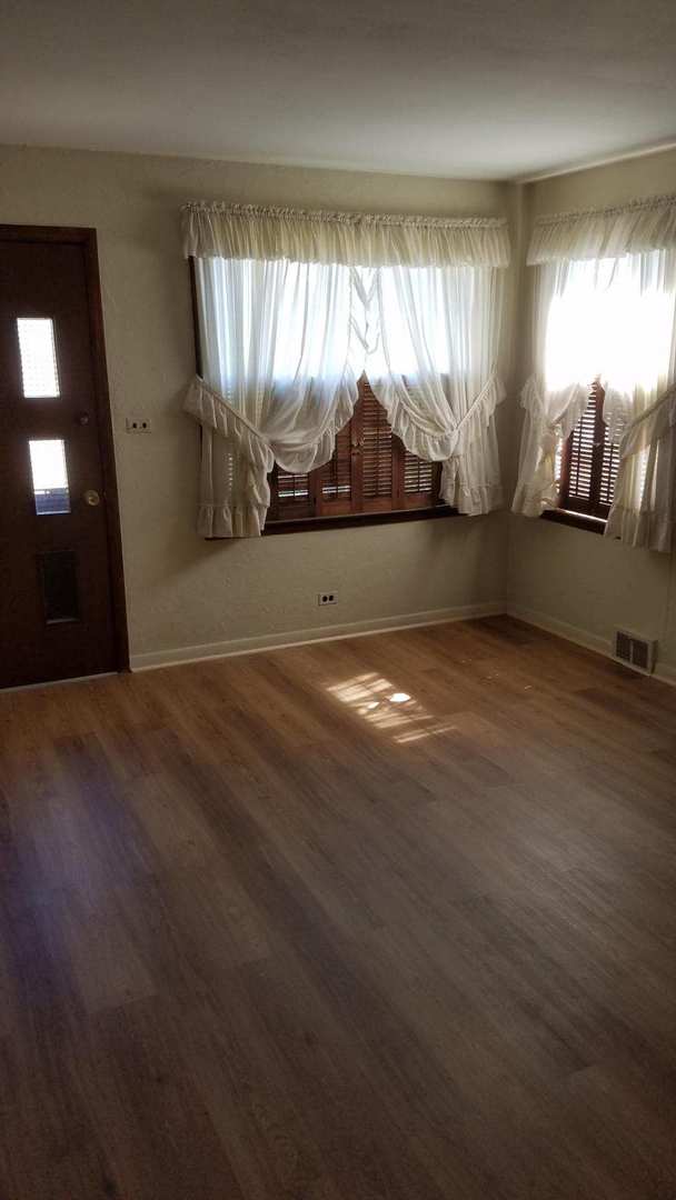 426 South Adeline Avenue Addison, IL 60101 - Photo 4 of 13 a view of big room with wooden floor and windows