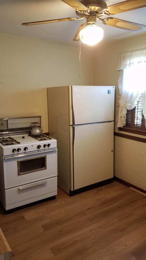 426 South Adeline Avenue Addison, IL 60101 - Photo 6 of 13 a white refrigerator freezer and a stove sitting inside of a kitchen