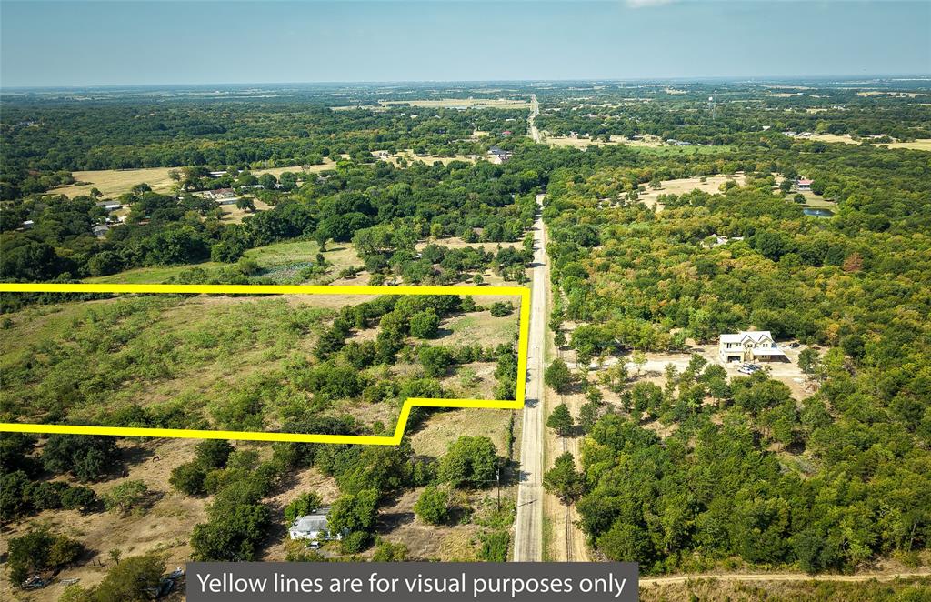 Tbd Stacks Road Ennis, TX 75119 - Photo 14 of 24 Expansive land parcel featuring a mix of open areas and mature trees, bordered by a paved road