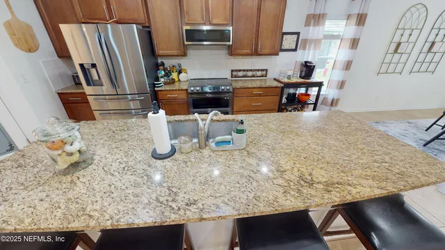 a kitchen with a sink and a stove top oven