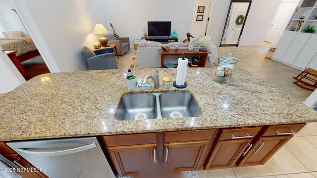 a kitchen with granite countertop a sink and a stove