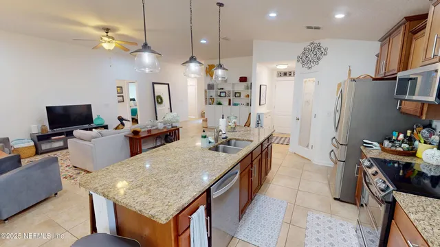 a kitchen with a stove a refrigerator and a dining table with wooden floor