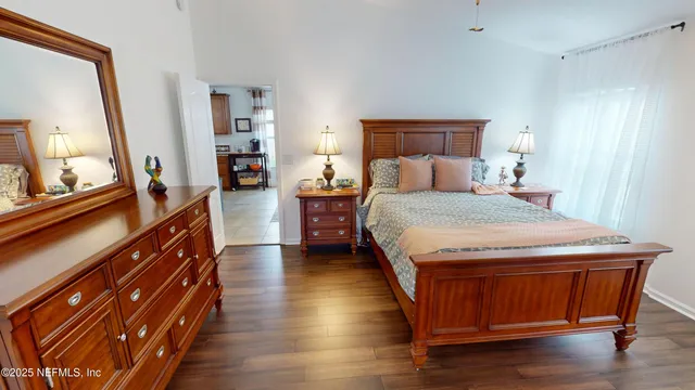 a bedroom with a bed and wooden floor