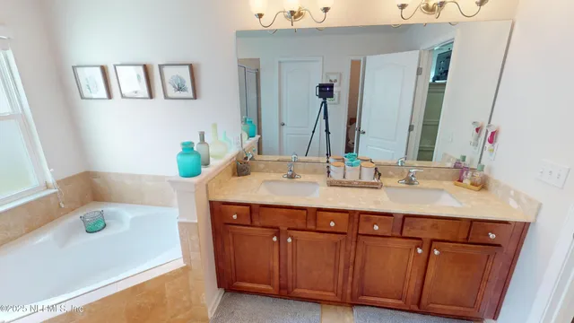 a bathroom with a tub sink and a mirror