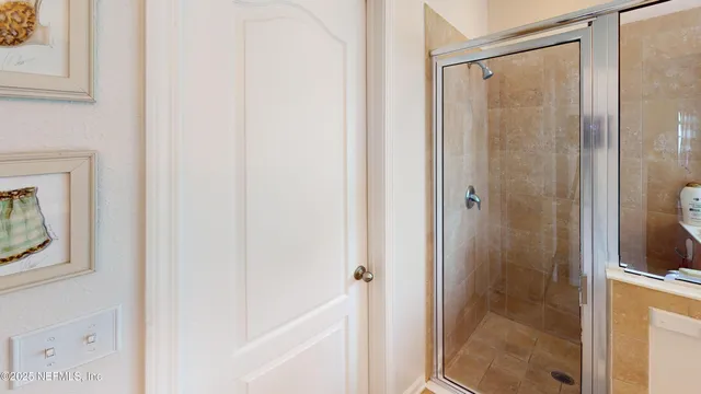 a bathroom with a glass shower door