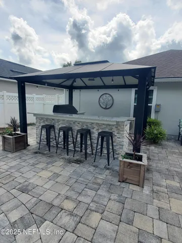 a view of a dinning table and chairs in the patio