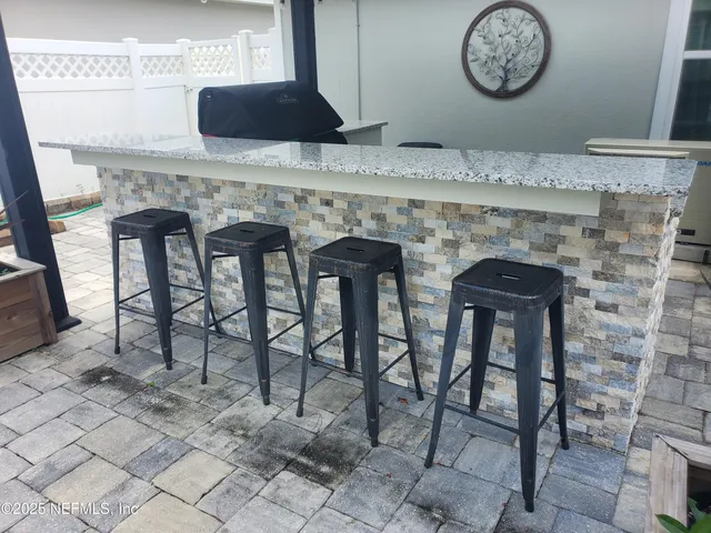 a living room with furniture a clock and a fireplace