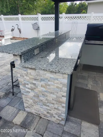 a kitchen with granite countertop a sink and a stove