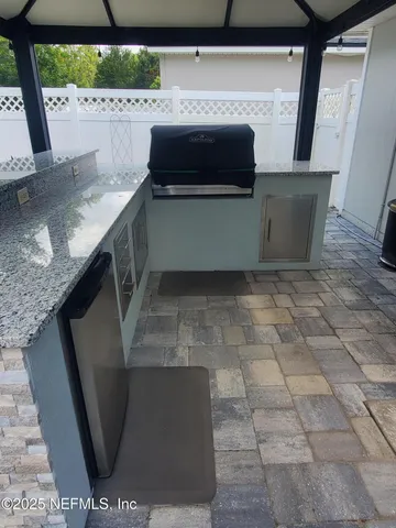 a view of kitchen with a sink and a stove
