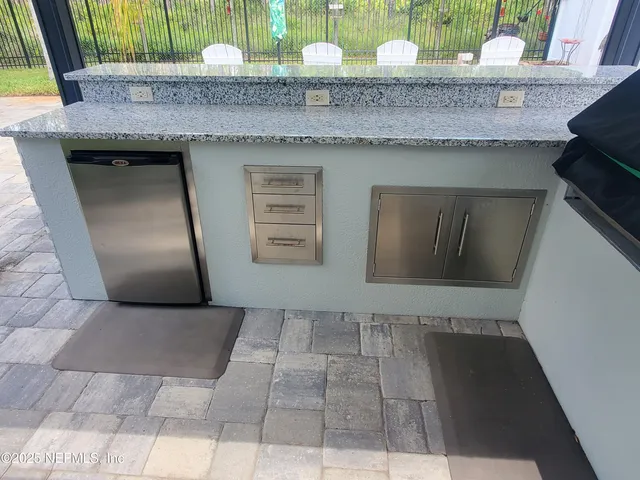 a bathroom with a granite countertop sink and mirror