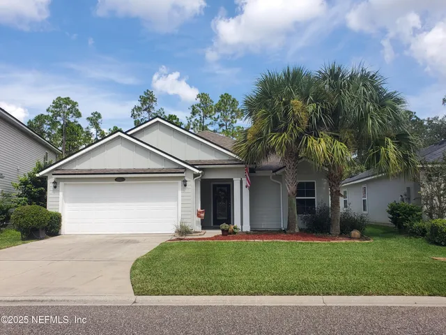 a front view of house with yard and green space