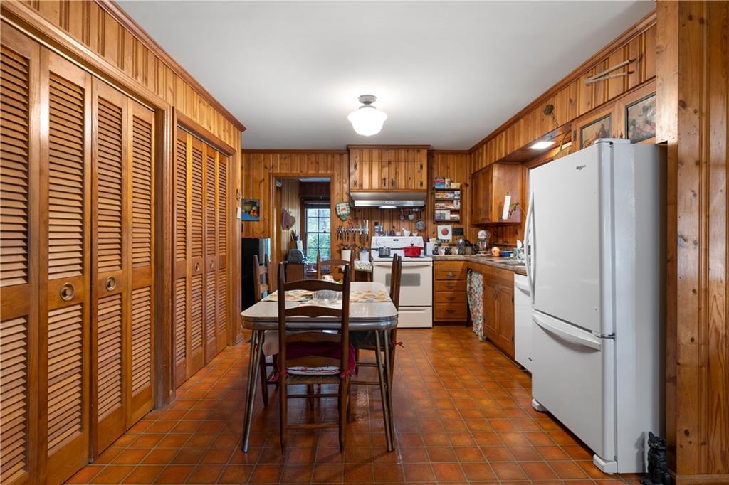 79 Floyd Road Southwest Cartersville, GA 30120 - Photo 12 of 50 a kitchen with granite countertop a refrigerator cabinets dining table and chairs