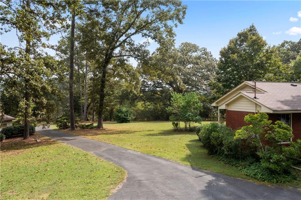 79 Floyd Road Southwest Cartersville, GA 30120 - Photo 31 of 50 a view of a house with a yard