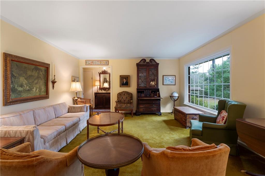 79 Floyd Road Southwest Cartersville, GA 30120 - Photo 9 of 50 a living room with fireplace furniture and a large window