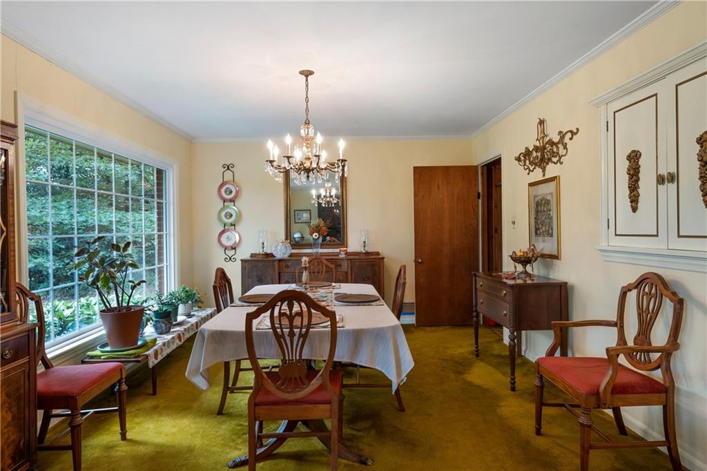 79 Floyd Road Southwest Cartersville, GA 30120 - Photo 10 of 50 a view of a dining room with furniture a chandelier and large windows