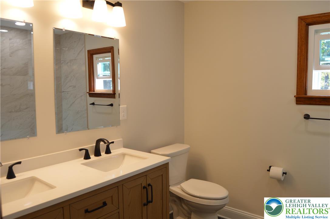 930 Morvale Road Easton, PA 18042 - Photo 24 of 36 a bathroom with a toilet a sink and mirror