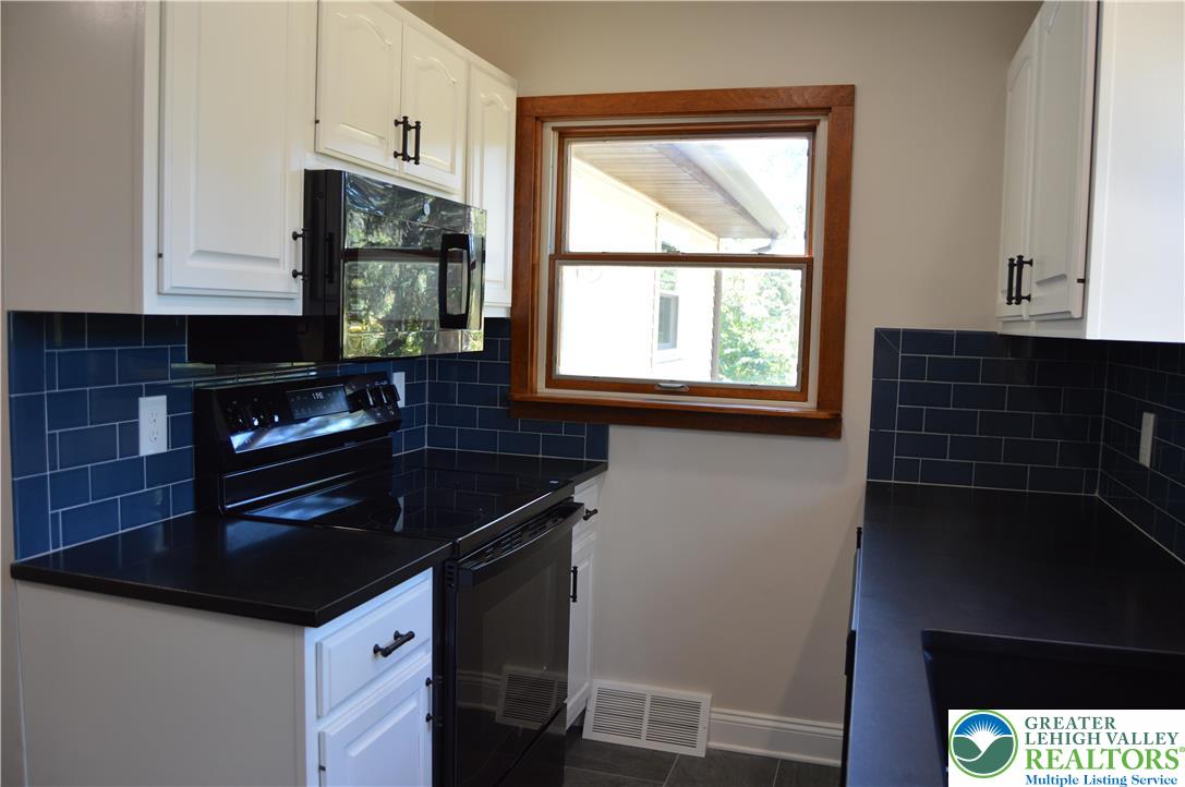 930 Morvale Road Easton, PA 18042 - Photo 10 of 36 a kitchen with granite countertop a sink and a stove