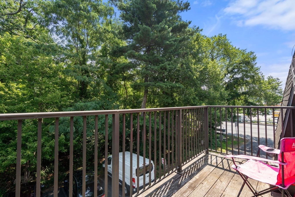 688 Boston Post Road East, Unit 304 Marlborough, MA 01752 - Photo 11 of 20 a balcony with wooden floor and fence