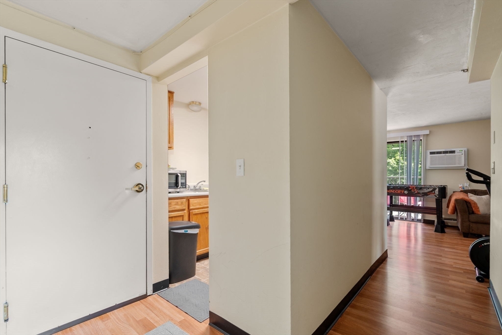 688 Boston Post Road East, Unit 304 Marlborough, MA 01752 - Photo 5 of 20 a view of a hallway with wooden floor windows and livingroom