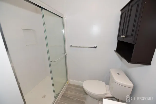 a white toilet sitting next to a small sink