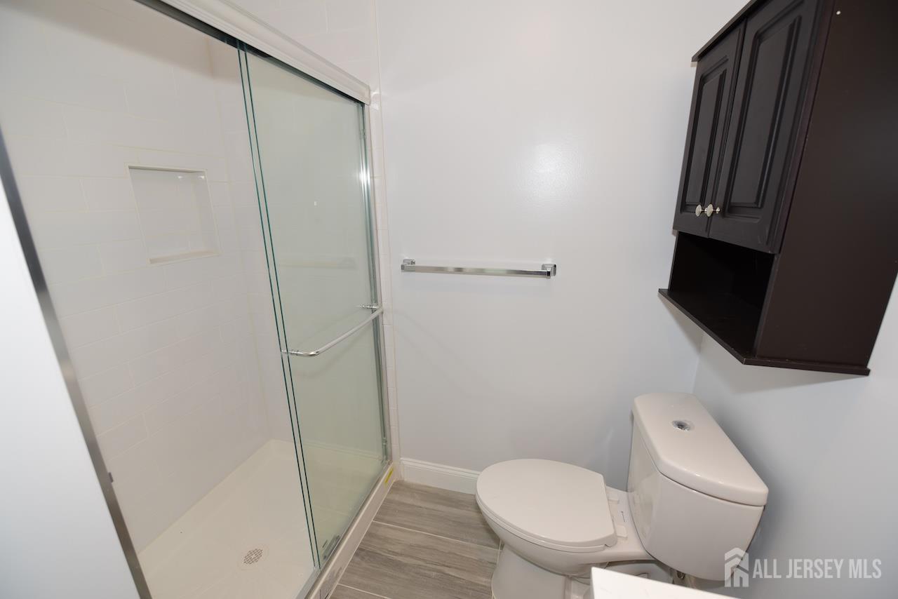 307 Hidden Village Drive Perth Amboy, NJ 08861 - Photo 11 of 18 a white toilet sitting next to a small sink