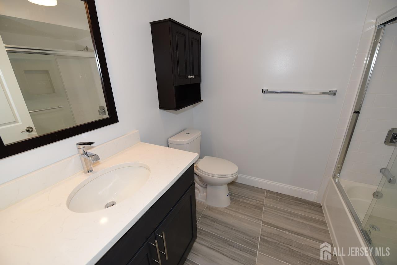 307 Hidden Village Drive Perth Amboy, NJ 08861 - Photo 12 of 18 a bathroom with a sink and a mirror