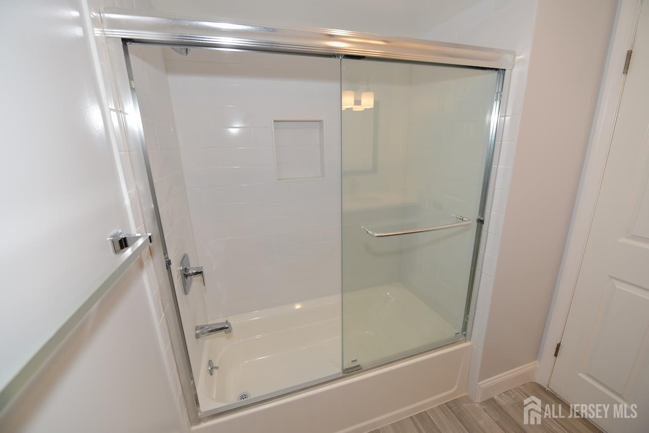 307 Hidden Village Drive Perth Amboy, NJ 08861 - Photo 13 of 18 a bathroom with a glass door shower