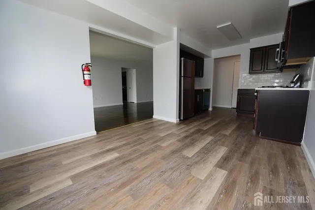 a view of kitchen with wooden floor and electronic appliances