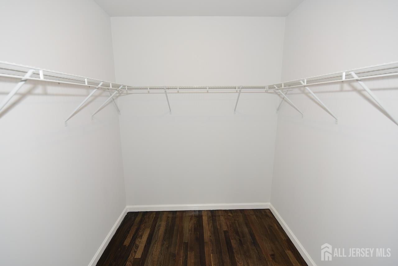307 Hidden Village Drive Perth Amboy, NJ 08861 - Photo 8 of 18 a view of walk in closet with empty racks