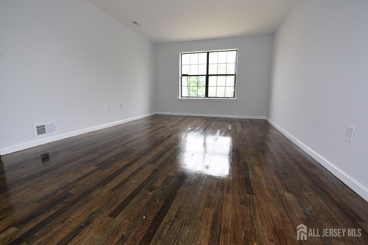 307 Hidden Village Drive Perth Amboy, NJ 08861 - Photo 9 of 18 wooden floor in an empty room