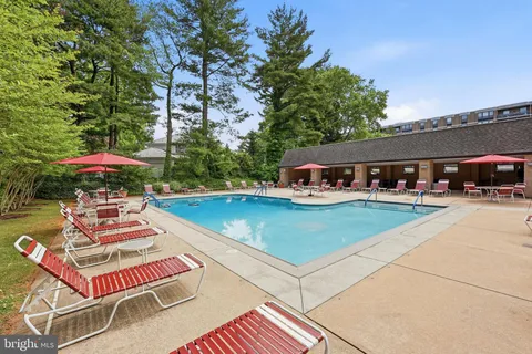 an outdoor space with swimming pool and furniture