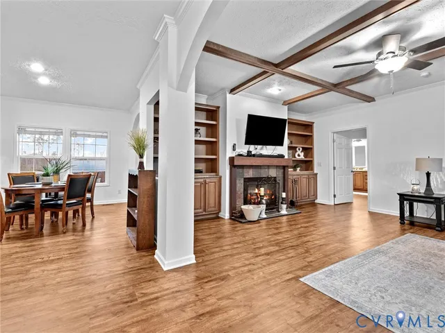 a kitchen with stainless steel appliances granite countertop a stove top oven a sink dishwasher and a refrigerator with wooden floor