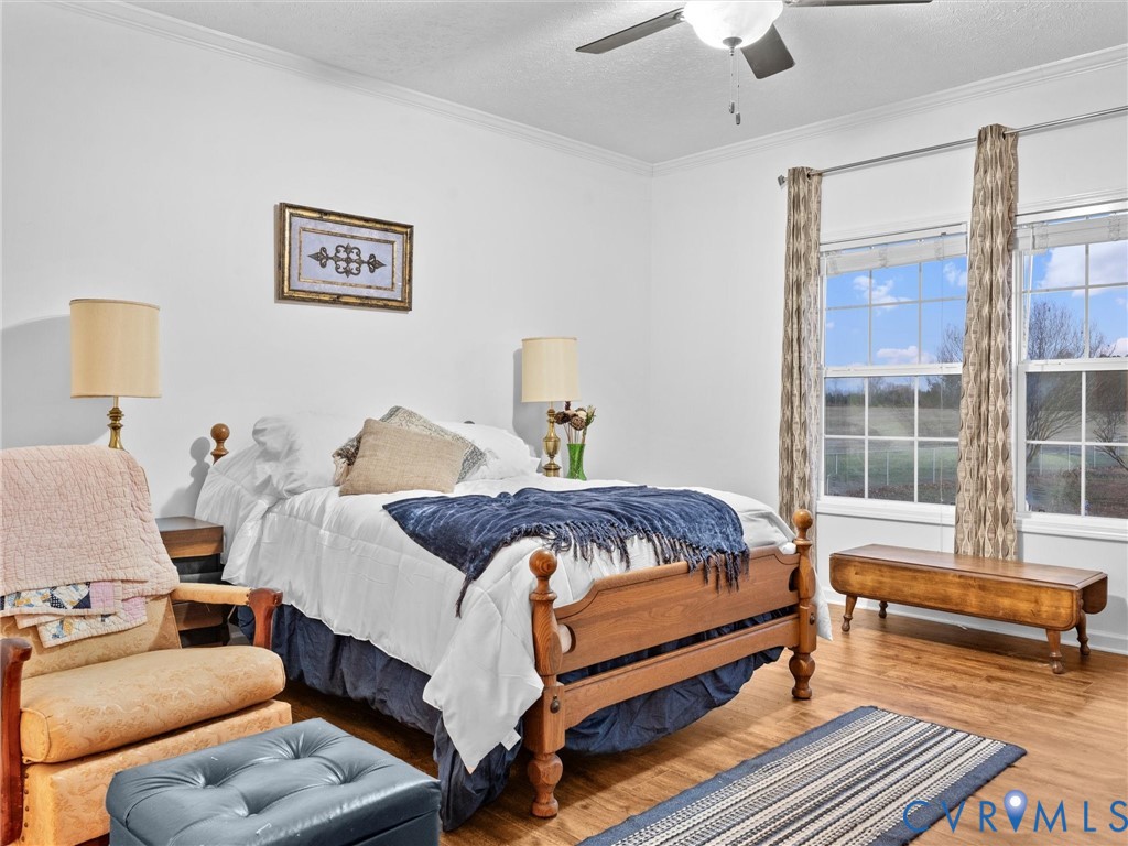 10885 Zilles Road Wilsons, VA 23894 - Photo 28 of 44 a bedroom with a bed and wooden floor