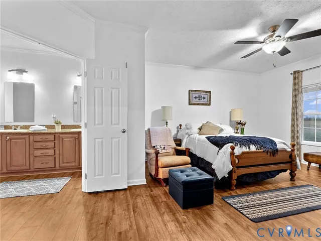 a spacious bedroom with a bed and a flat screen television