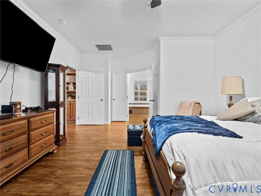 10885 Zilles Road Wilsons, VA 23894 - Photo 31 of 44 a spacious bedroom with a bed and a flat screen television