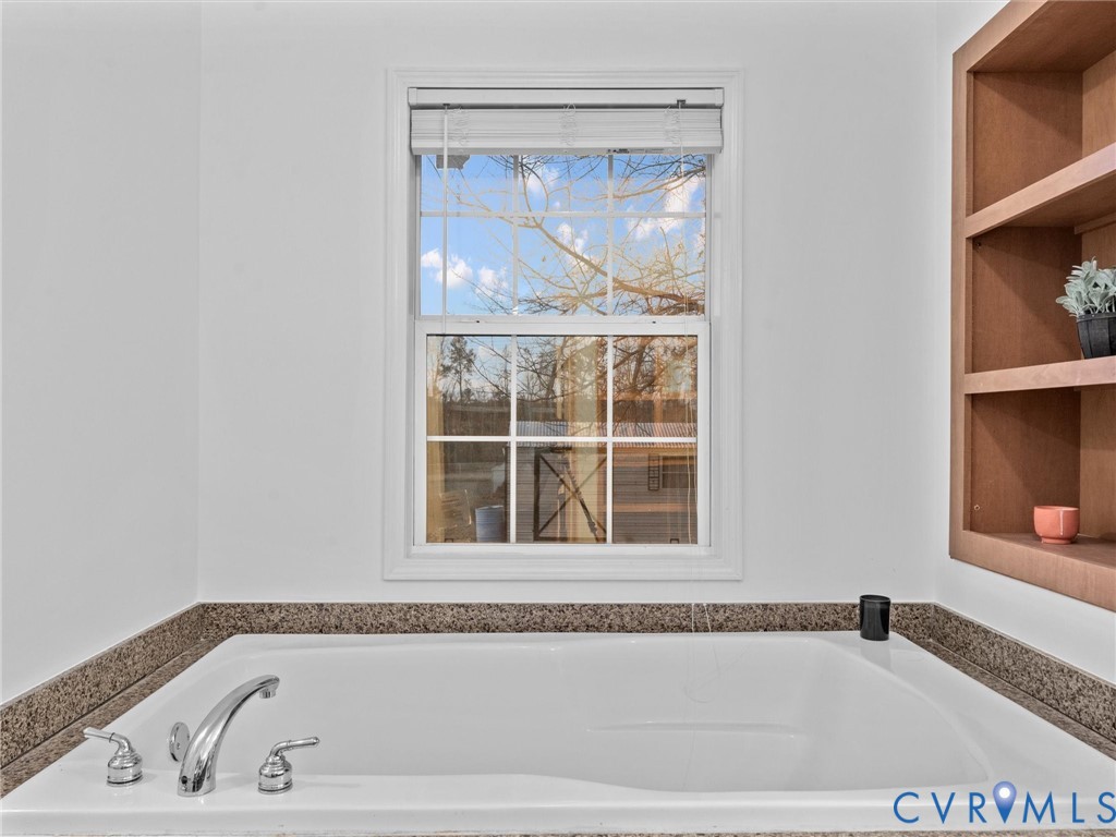 10885 Zilles Road Wilsons, VA 23894 - Photo 33 of 44 a bathroom with bathtub and window