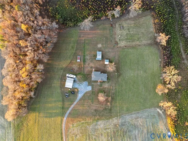 a view of a house with a big yard and large tree