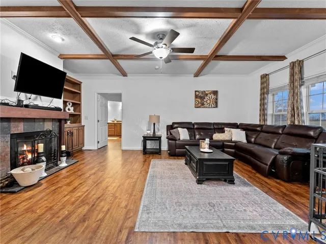 a living room with furniture a flat screen tv and a table