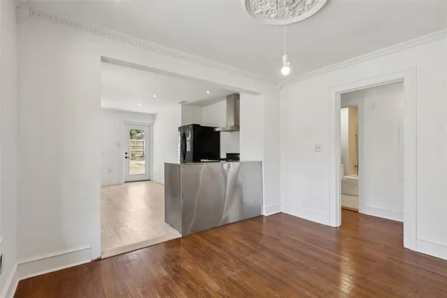a view of a kitchen with a sink and a refrigerator