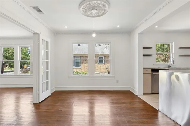 an empty room with wooden floor and a window