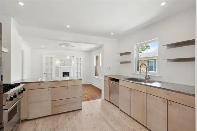 a spacious bathroom with a granite countertop sink and a mirror