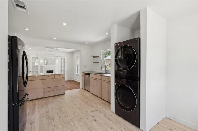 a view of a kitchen with a washer and dryer