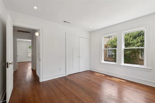 a view of a livingroom with wooden floor and window