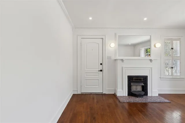 a view of a livingroom with a fireplace and wooden floor