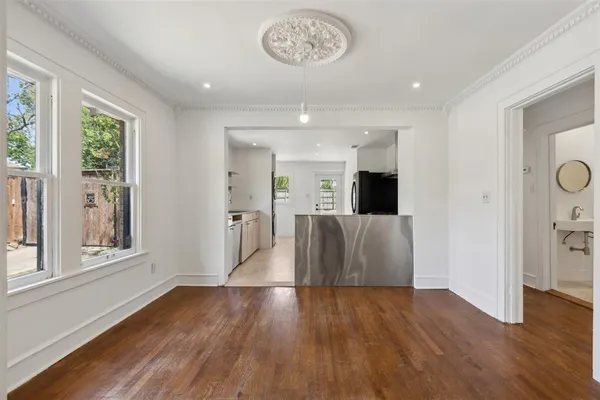 wooden floor in an empty room with a window