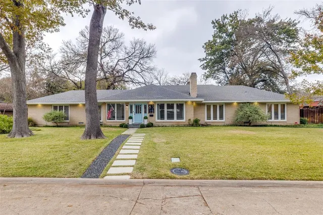 a front view of a house with swimming pool having outdoor seating