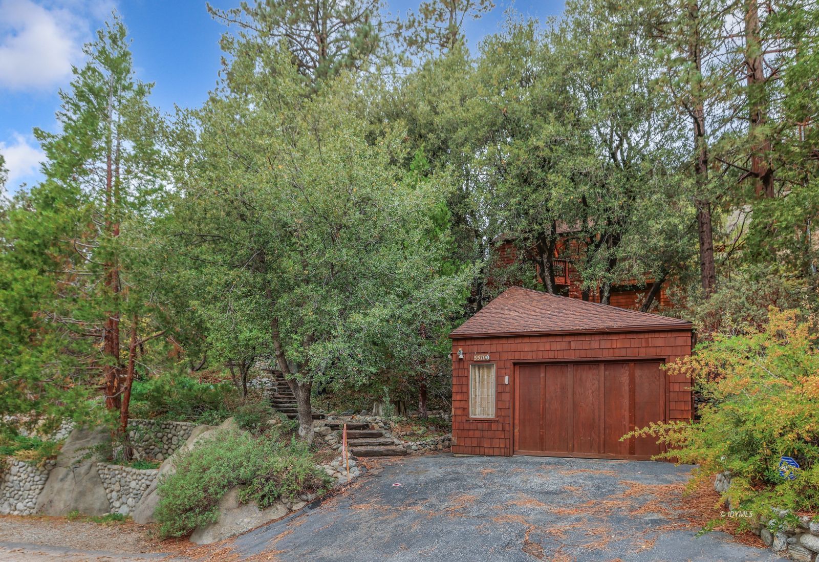 a house that has a tree in front of it