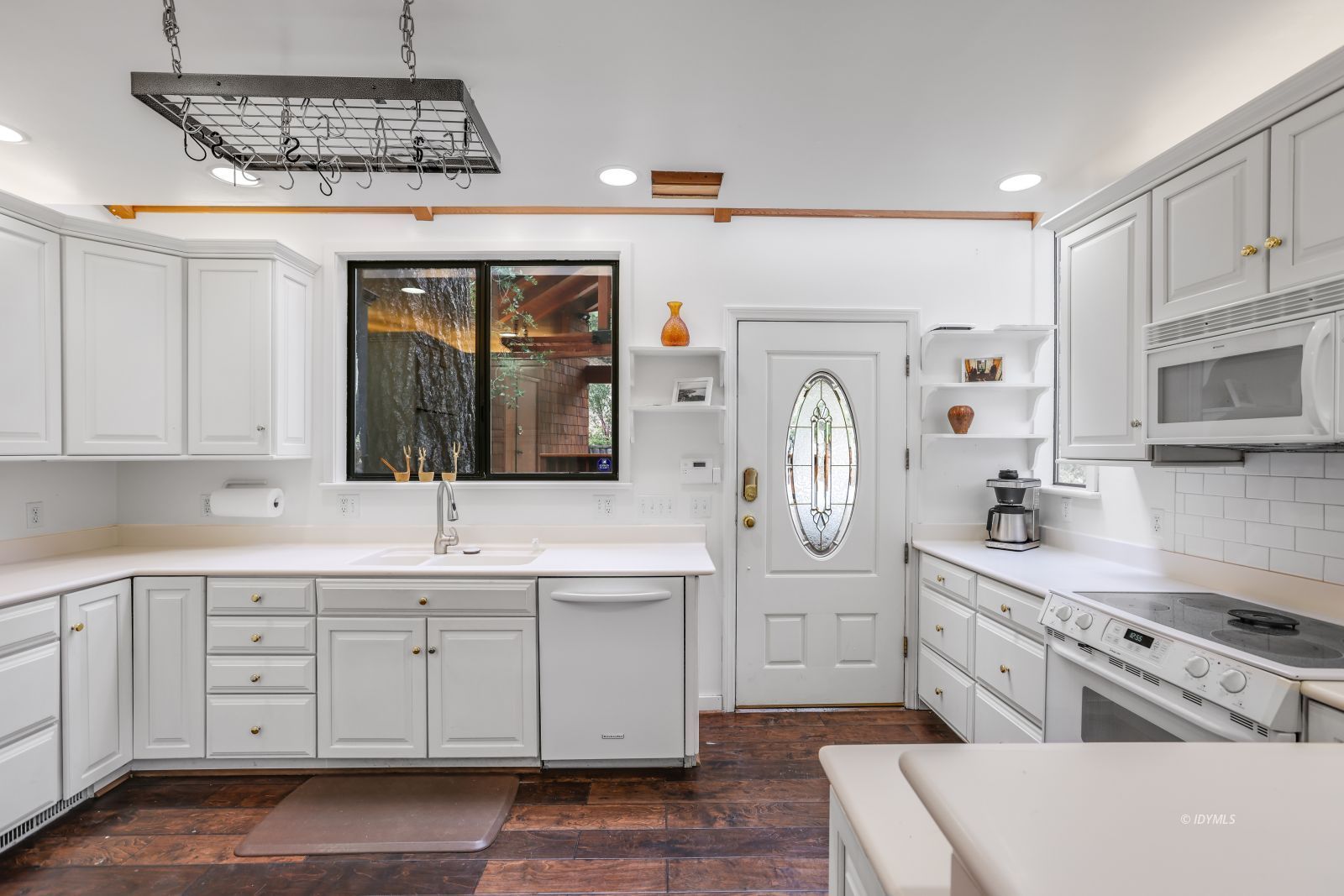 55100 Pine Crest Avenue Idyllwild, CA 92549 - Photo 14 of 50 a kitchen with white cabinets and white appliances